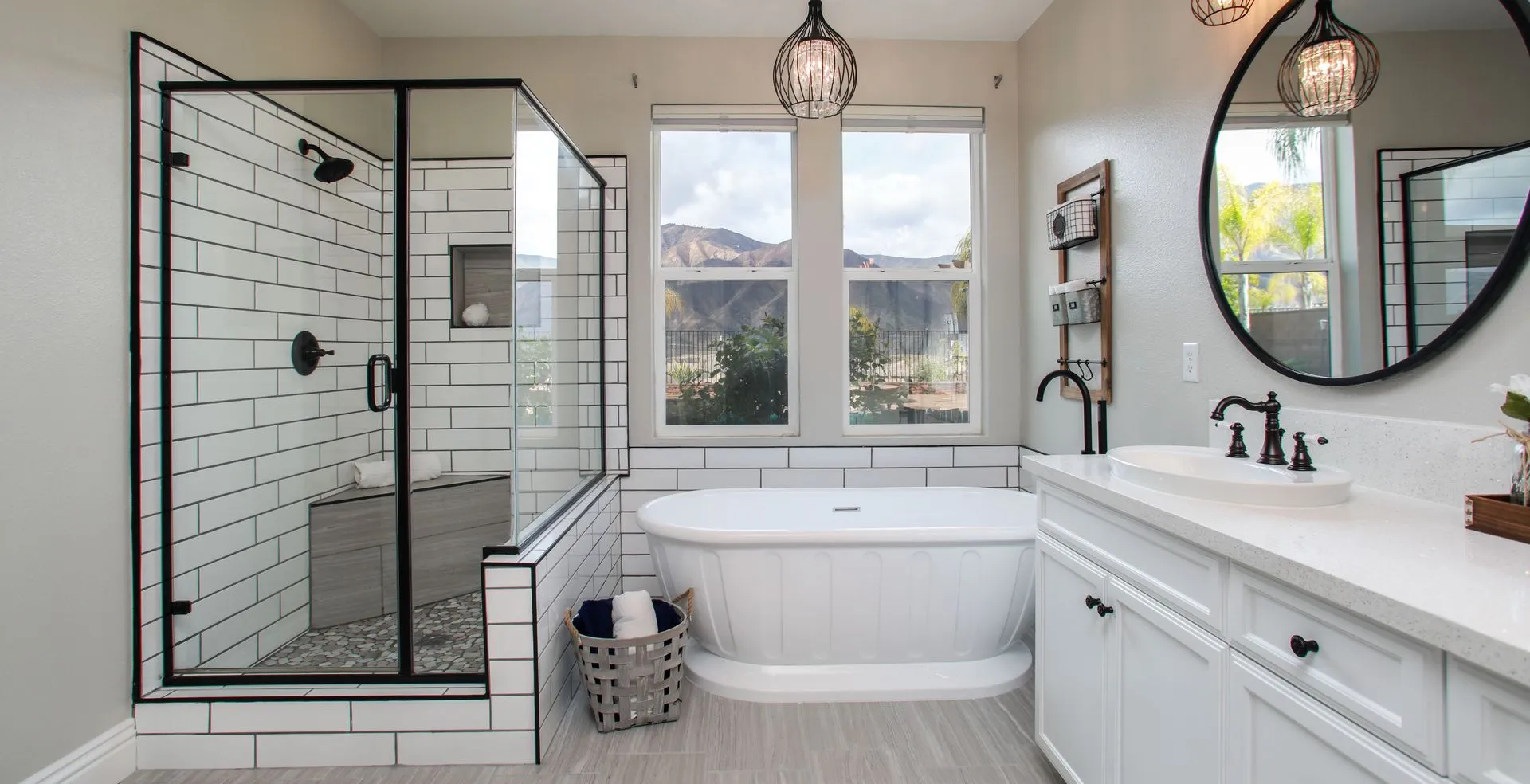 Bathroom with white tile walls and cleart glass shower doors with black trim