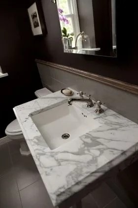 Bathroom vanity with marble countertop and silver faucet