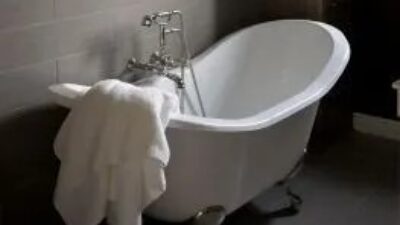 Claw foot bathtub with towel over the side