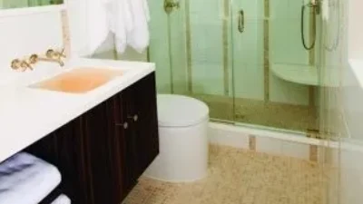 Bathroom with Kohler Purist sconces in French gold